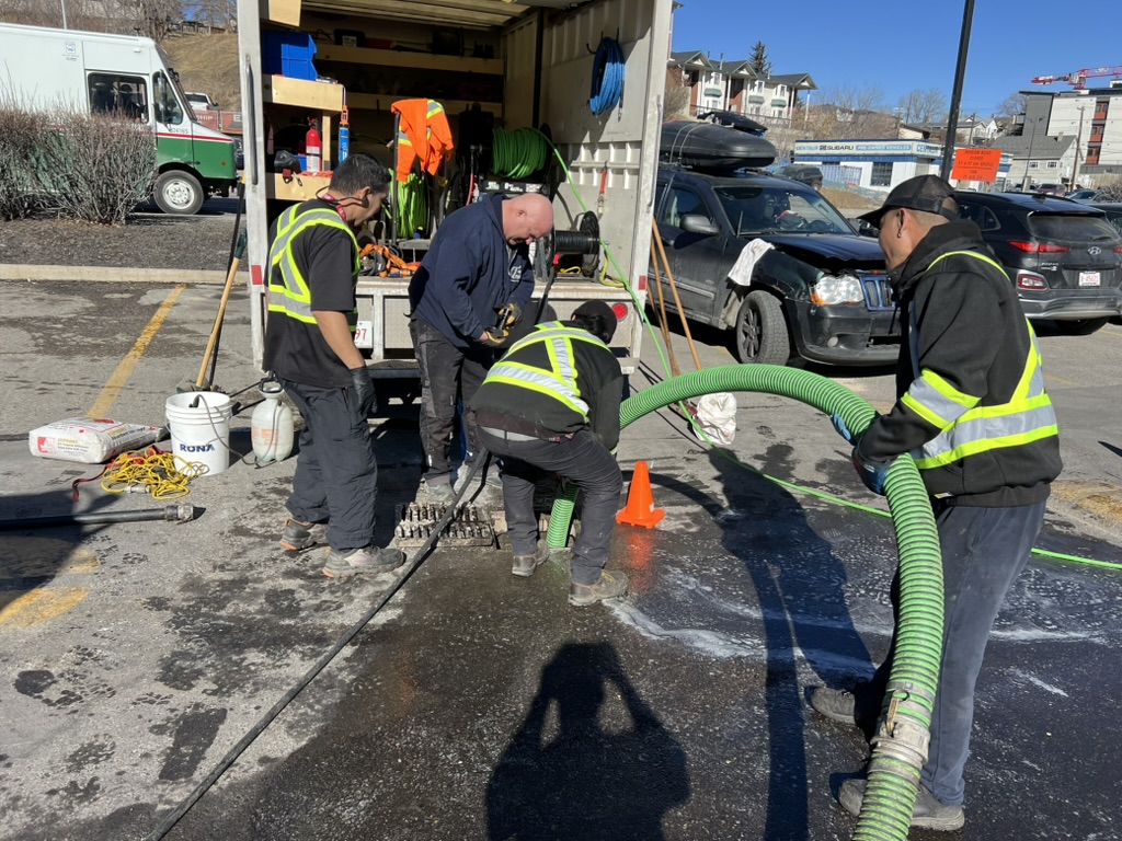 Technician working on grease-related drainage for a Calgary restaurant
