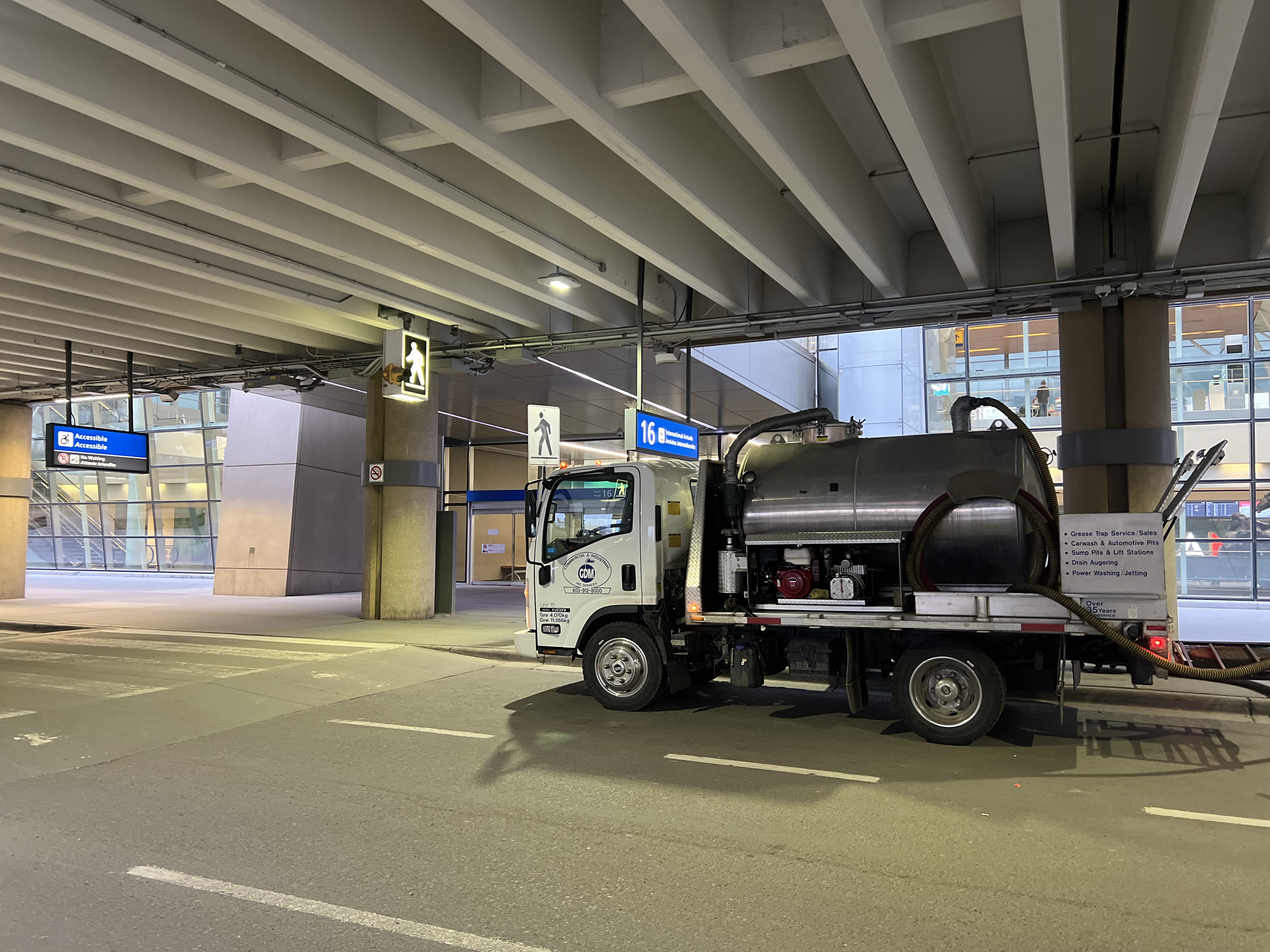 High-pressure hose setup during a GDM Vac grease line jetting job in Calgary