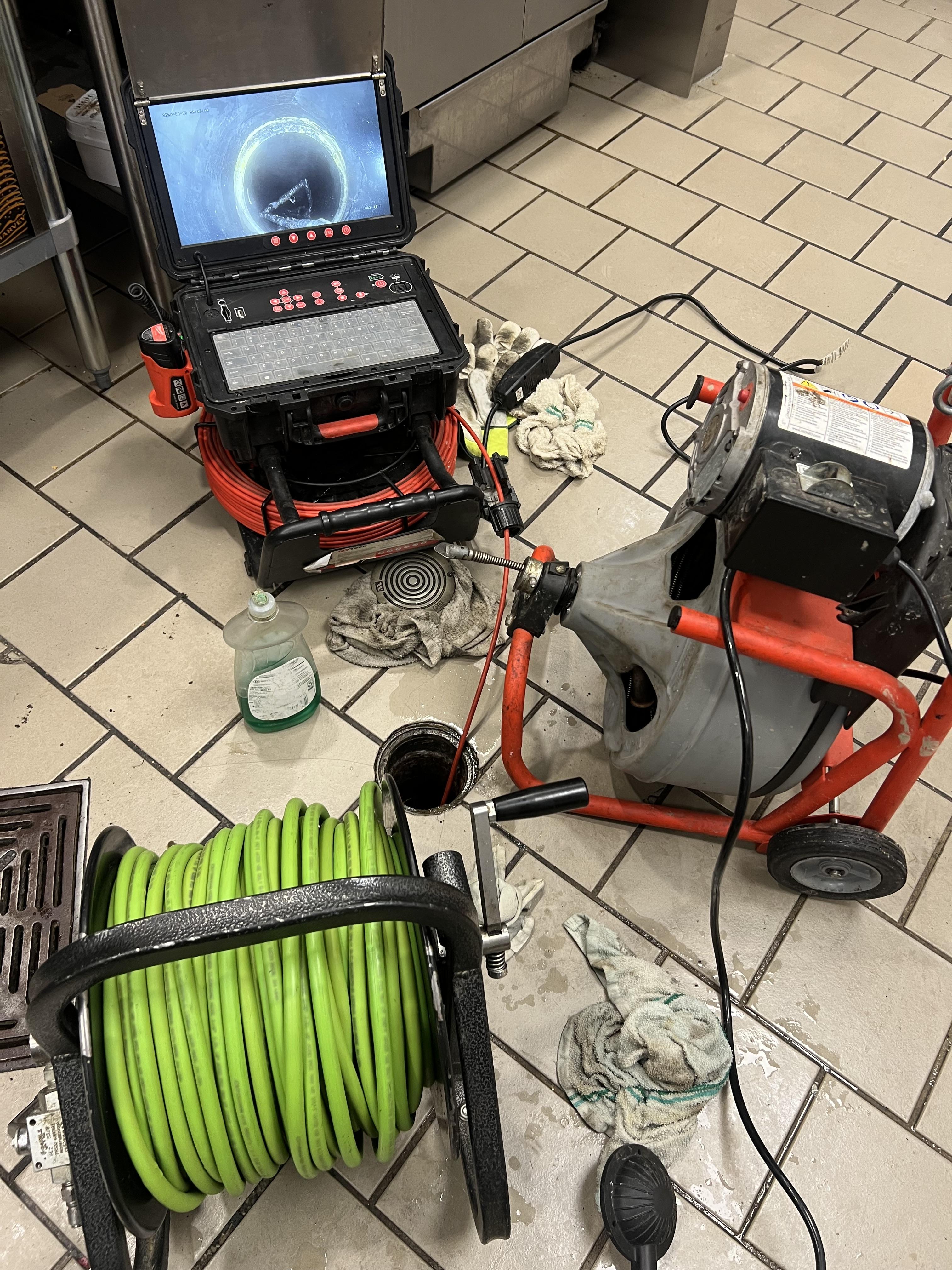 GDM Vac hoses set up through plaza access panels for grease trap service